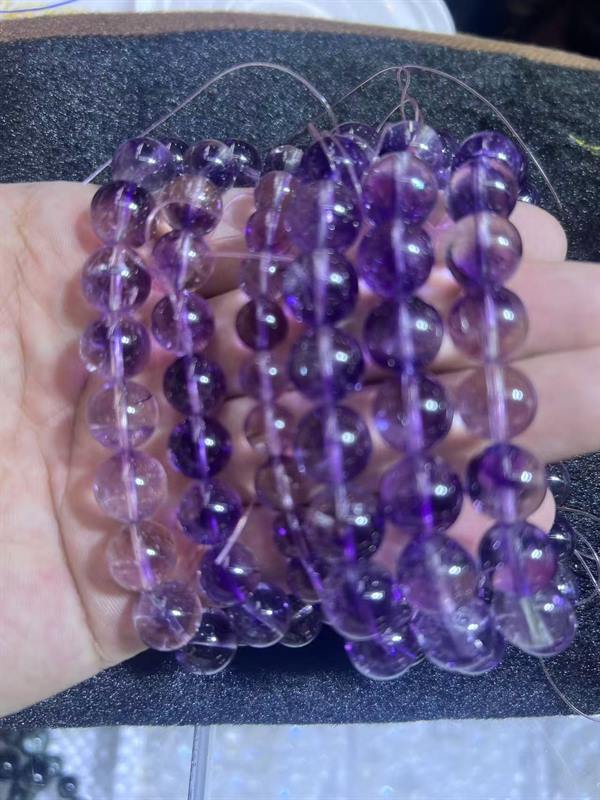 Purple rutilated quartz beads from a production lot